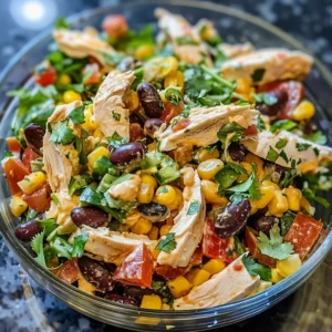 Close-up of a zesty southwest chicken salad in a glass bowl.